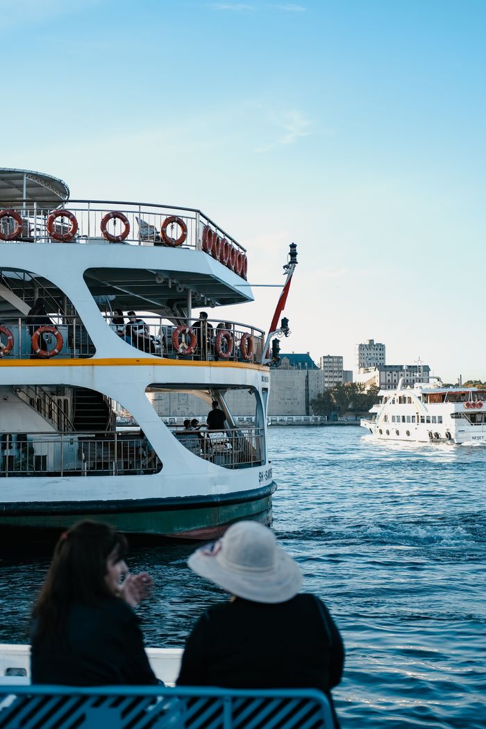 summer-sale A relaxing river cruise with a ferry filled with passengers enjoying the outdoors.