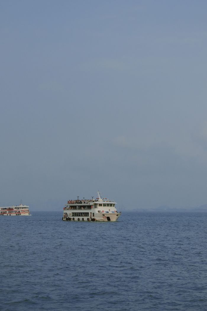 delivery-policy A tranquil ferry voyage captured on a clear day, emphasizing travel and leisure on the open sea.